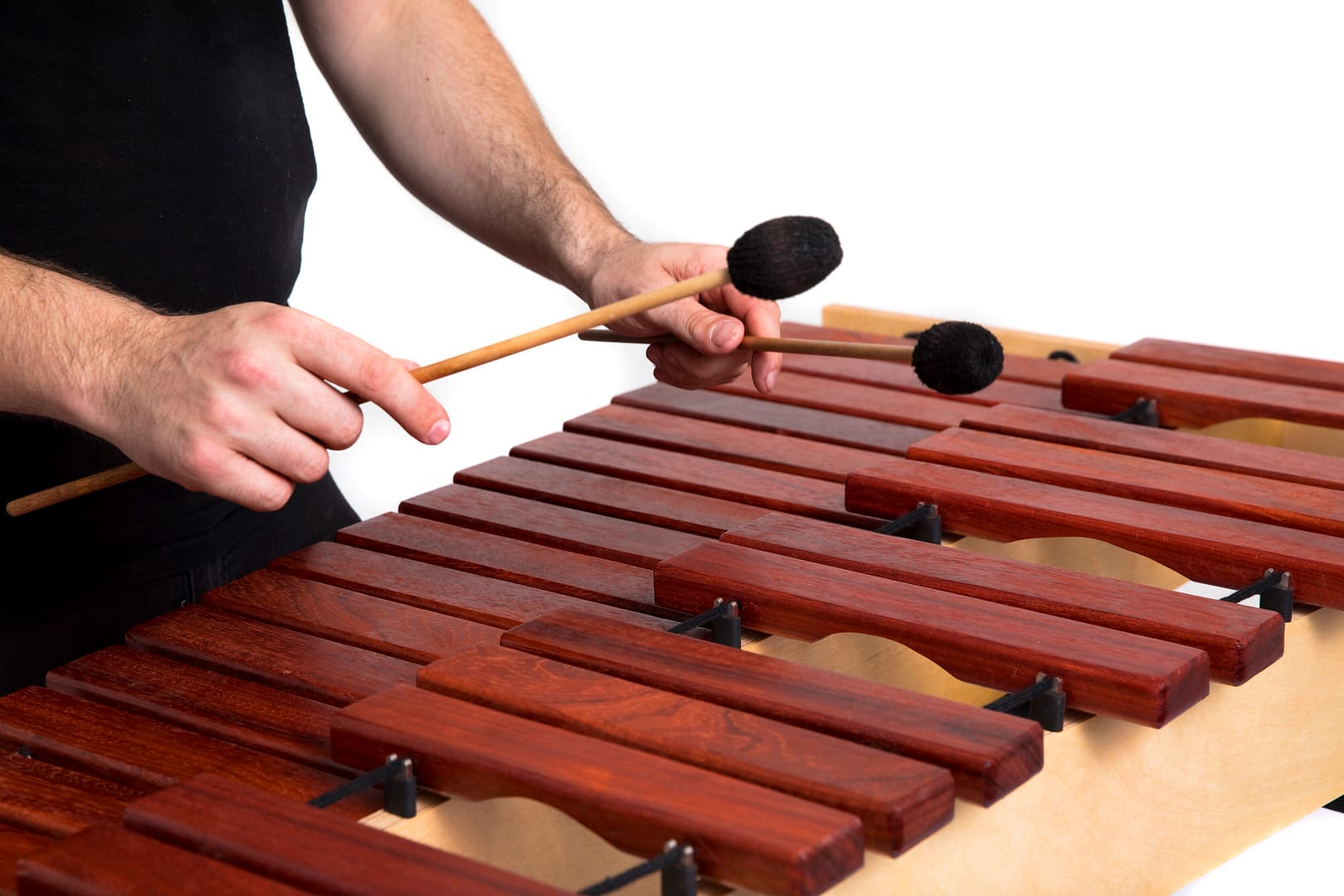 A percussionist plays the marimba with mallets