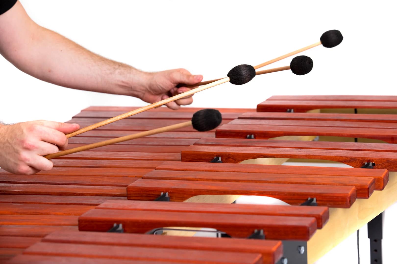 A percussionist plays the marimba with mallets
