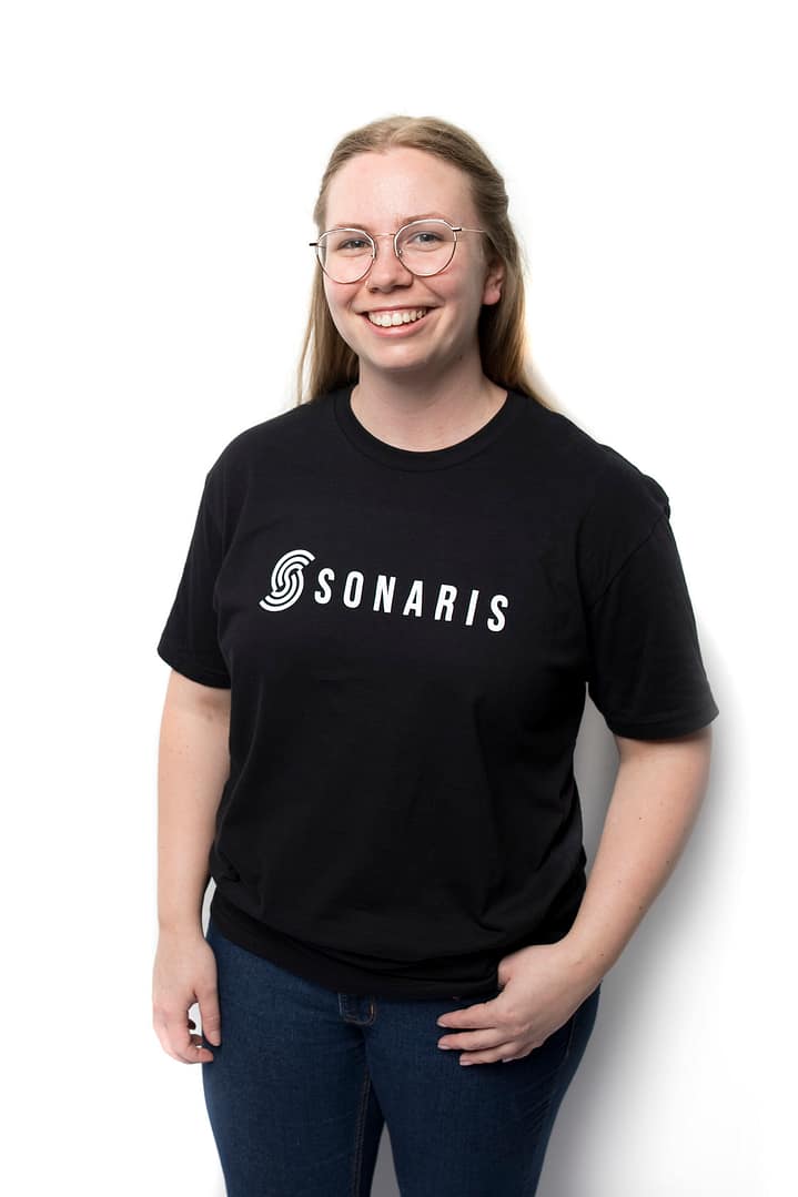 Female model wearing black t-shirt with white Sonaris logo